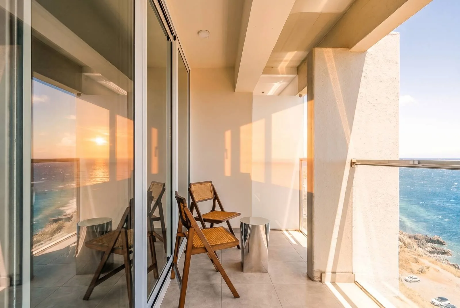 Balcony at Horizon Living with an ocean view in the setting sun